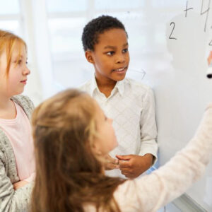 image of students calculating at a whiteboard